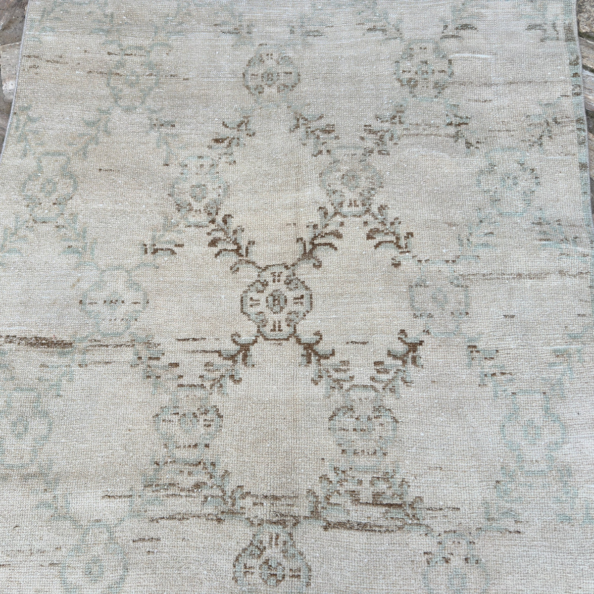 1970s beige vintage turkish rug with geometric design, hand-knotted weave and low pile.