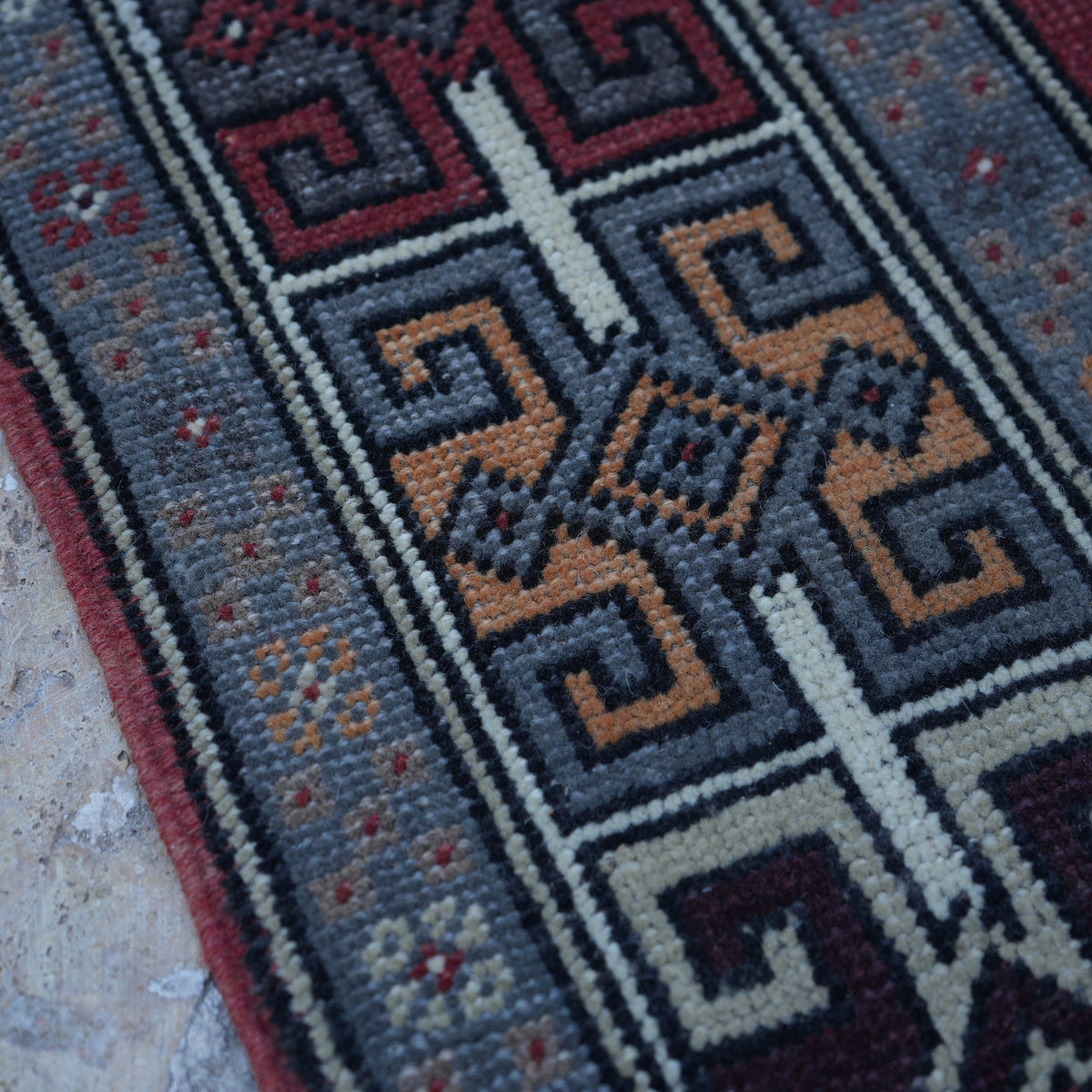 Red 4' x 10' vintage turkish rug in wool, shown on the floor.