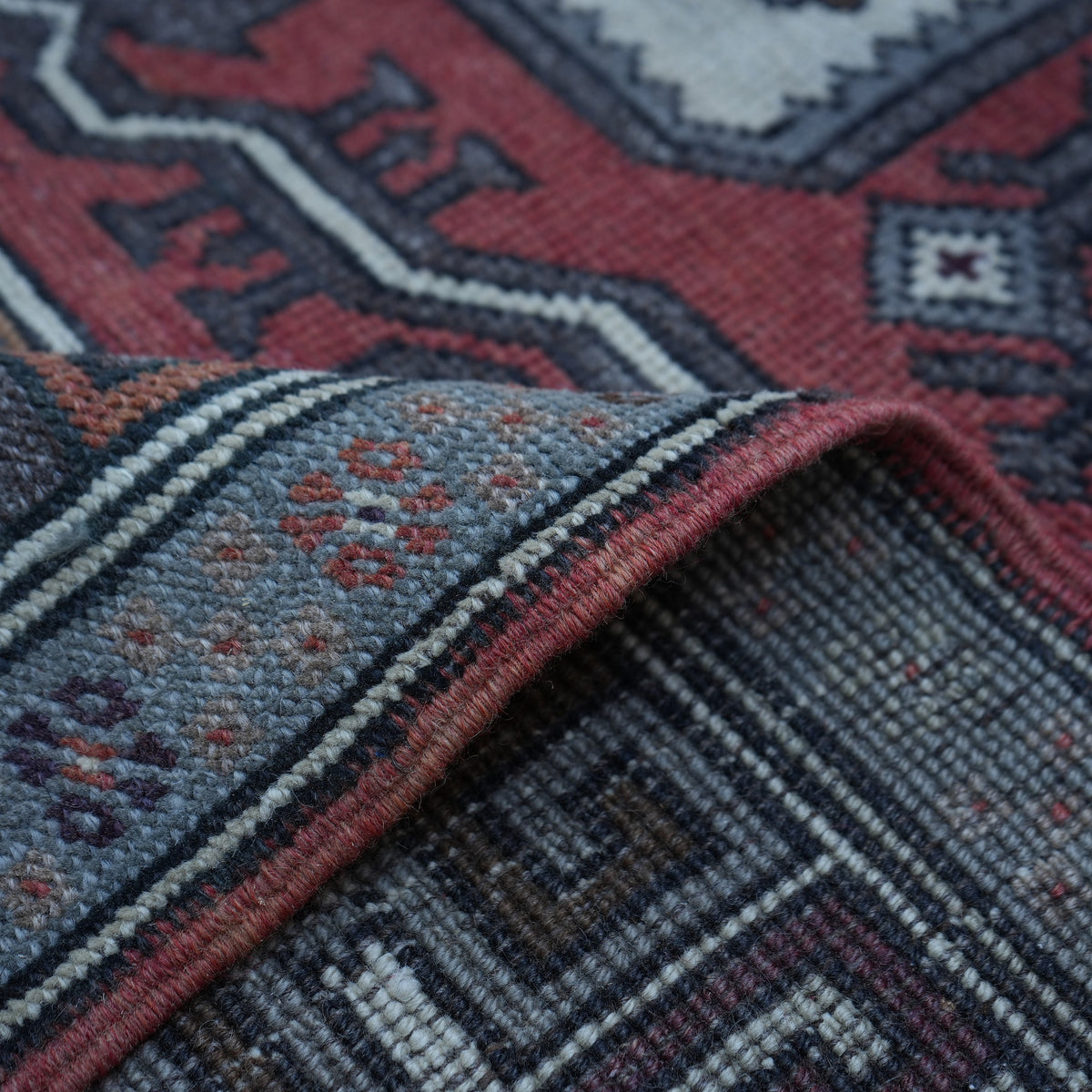 Additional view of the red vintage turkish rug, hand-knotted in wool.
