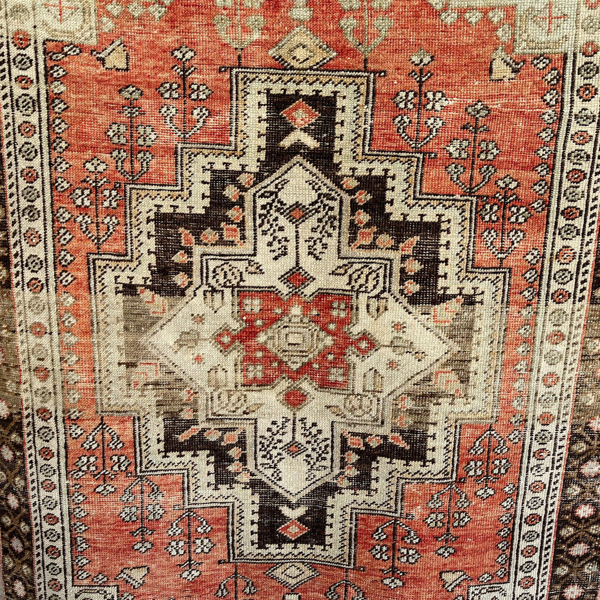 Red 4' x 6' vintage turkish rug in wool and cotton, shown on the floor.