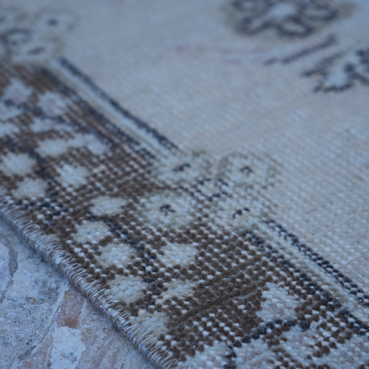 Beige 4' x 7' vintage turkish rug in wool and cotton, shown on the floor.