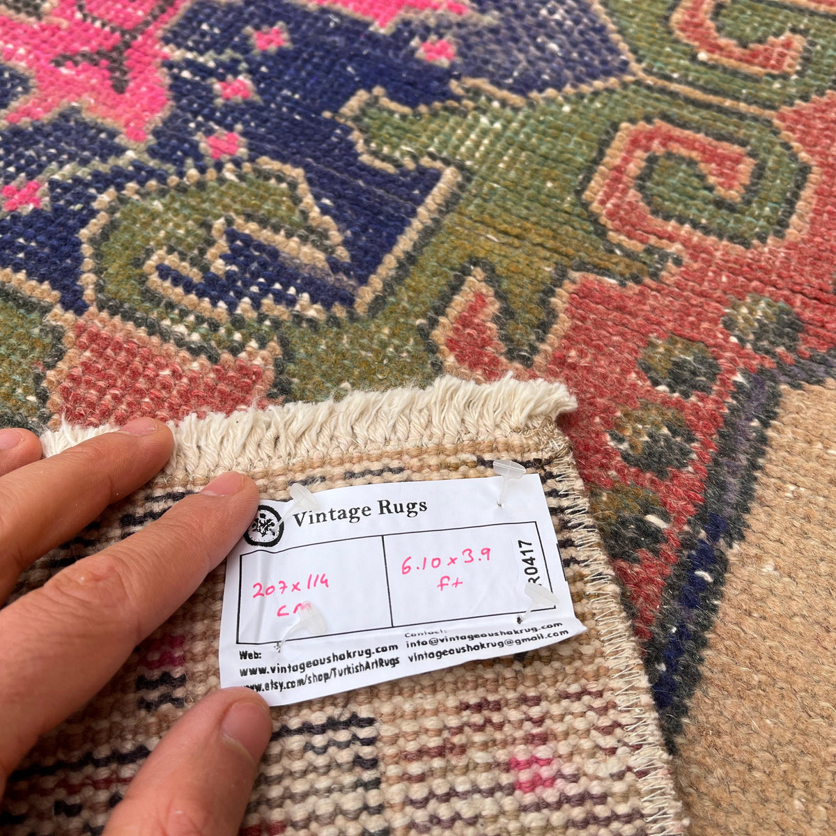 Close-up of the blue vintage turkish rug showing traditional details, hand-knotted weave, wool and cotton and low pile.
