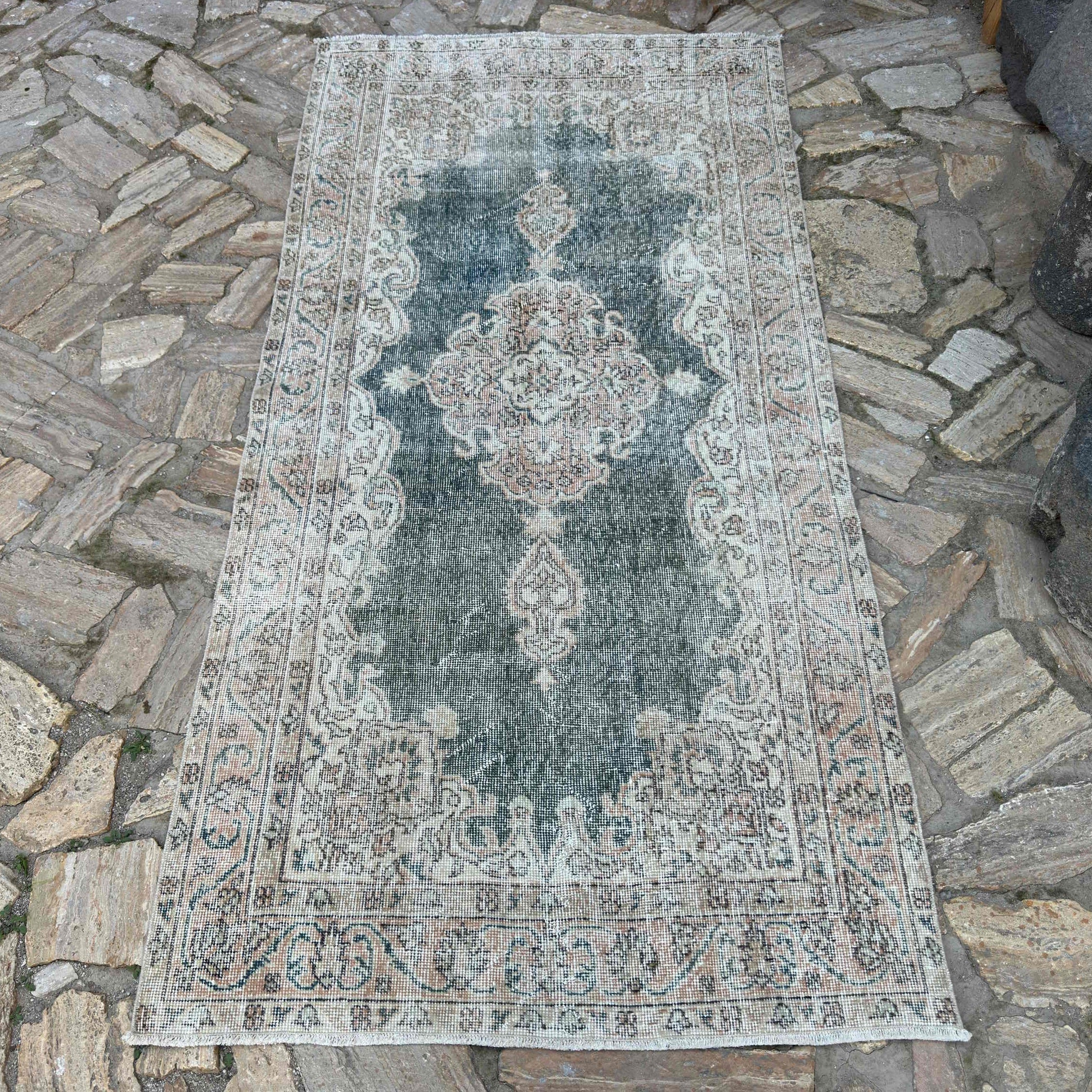 Blue 4' x 7' vintage turkish rug in wool and cotton, shown on the floor.