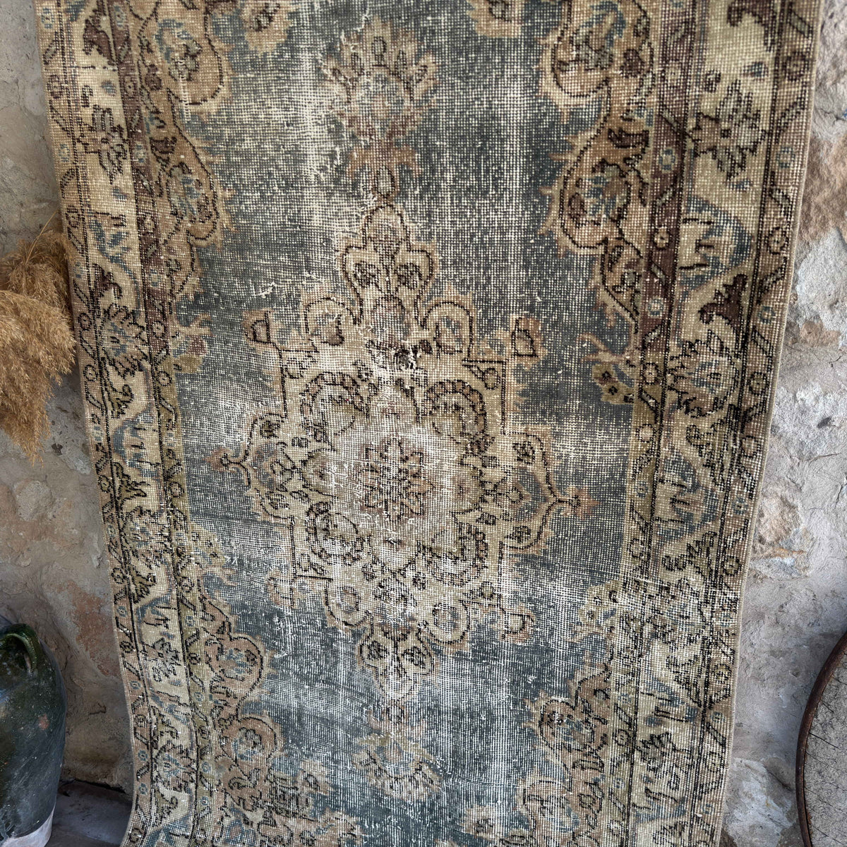 Blue 4' x 7' vintage turkish rug in wool and cotton, shown on the floor.