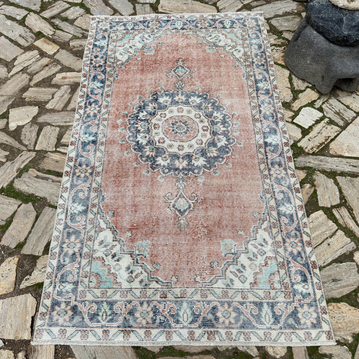 Blue 4' x 7' vintage turkish rug in wool and cotton, shown on the floor.
