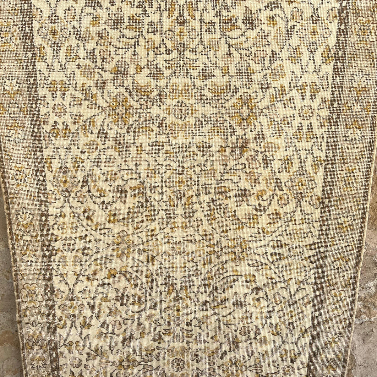 Brown 4' x 7' vintage turkish rug in wool and cotton, shown on the floor.