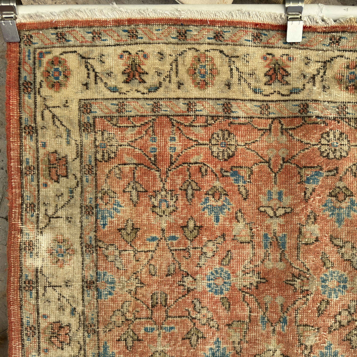 1970s orange vintage turkish rug with floral design, hand-knotted weave and low pile.