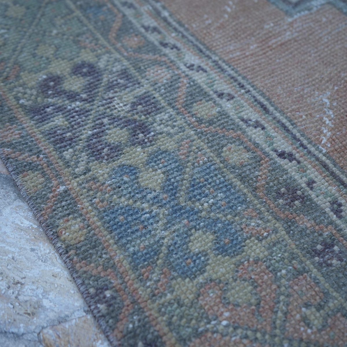 Orange 4' x 7' vintage turkish rug in wool, shown on the floor.