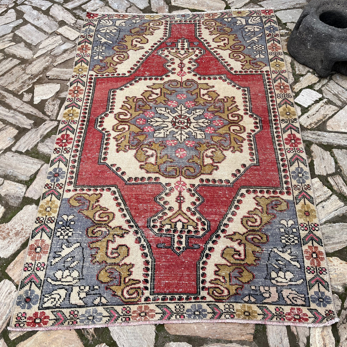 Red 4' x 7' vintage turkish rug in wool and cotton, shown on the floor.