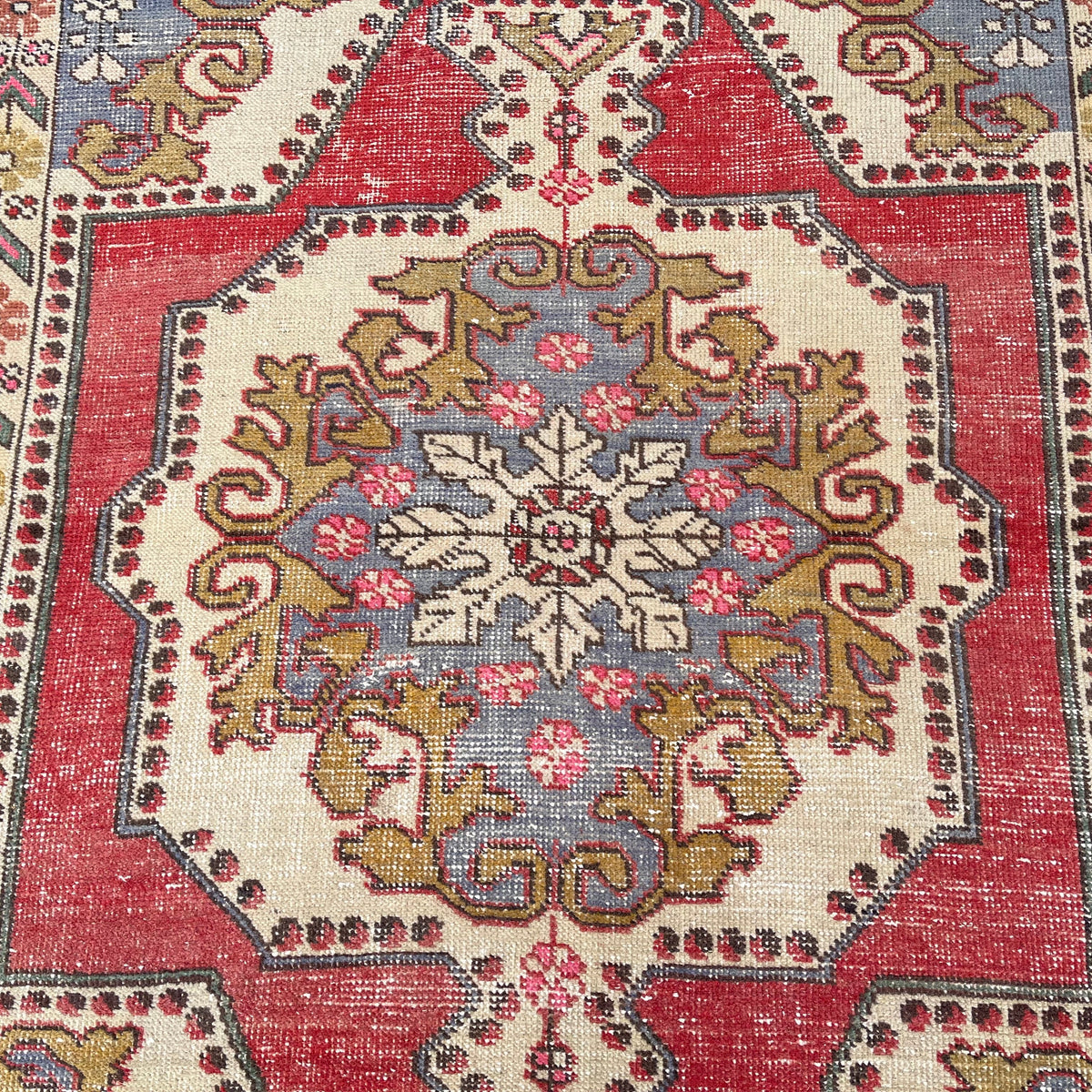 1970s red vintage turkish rug with traditional design, hand-knotted weave and low pile.