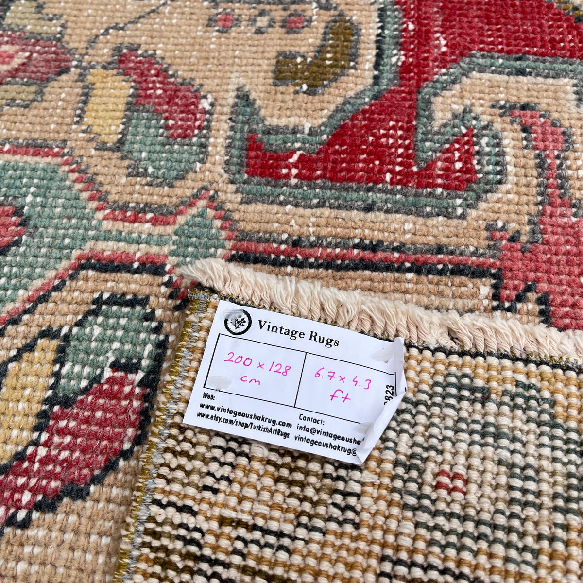 Close-up of the yellow vintage turkish rug showing geometric details, hand-knotted weave, wool and cotton and low pile.