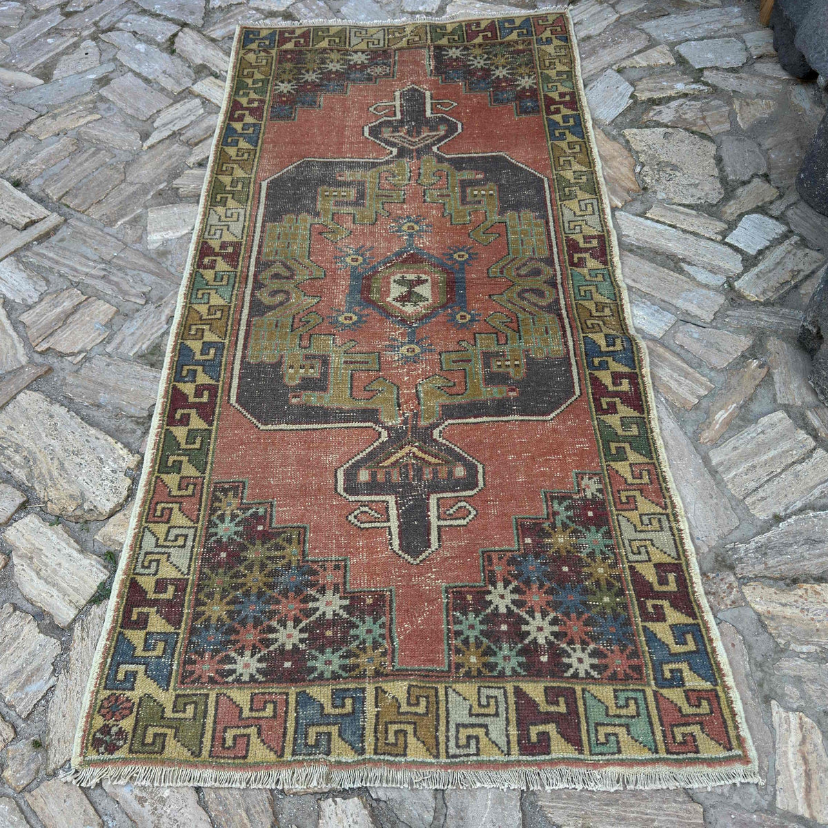 Pink 4' x 8' vintage turkish rug in wool and cotton, shown on the floor.