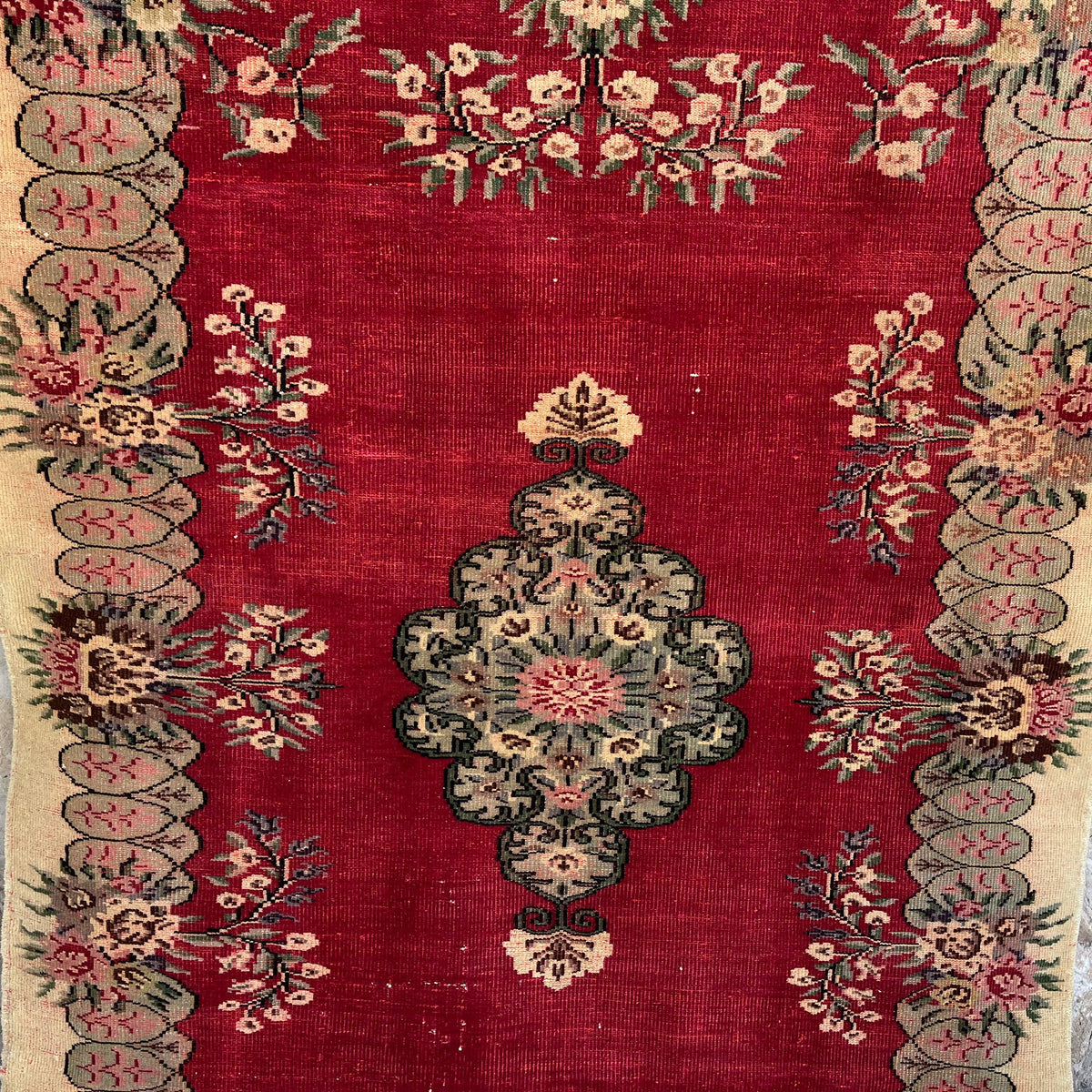 Red 5' x 7' vintage turkish rug in wool and cotton, shown on the floor.