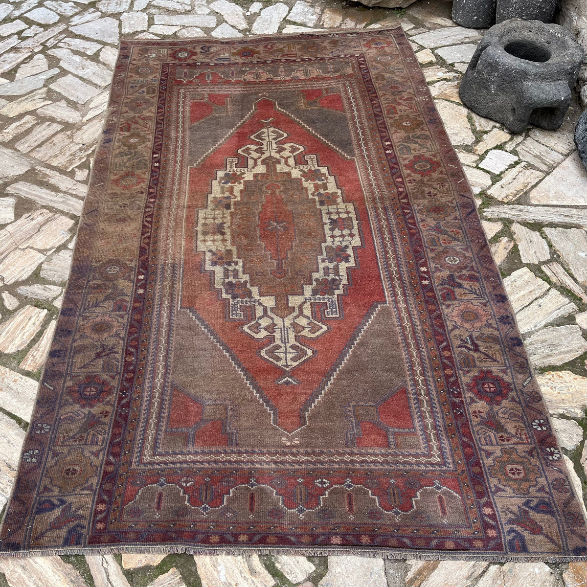 Red 5' x 8' vintage turkish rug in wool and cotton, shown on the floor.
