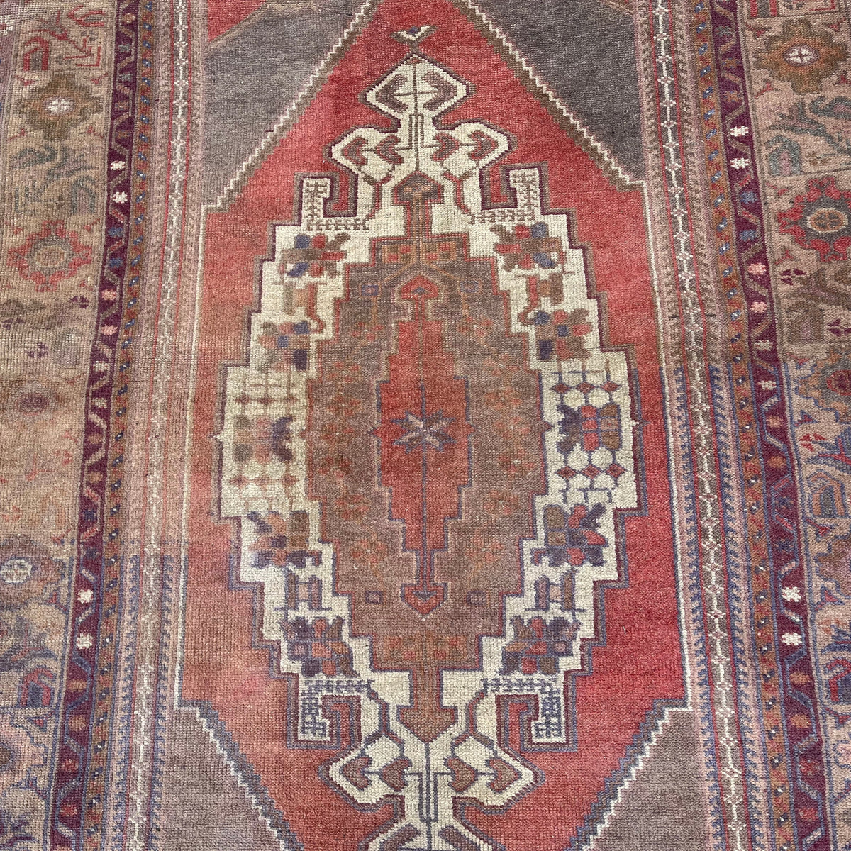1970s red vintage turkish rug with traditional design, hand-knotted weave and low pile.