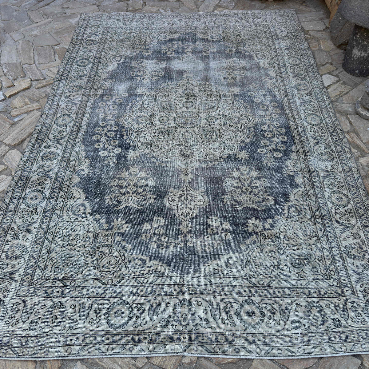 Beige 6' x 10' vintage turkish rug in wool and cotton, shown on the floor.