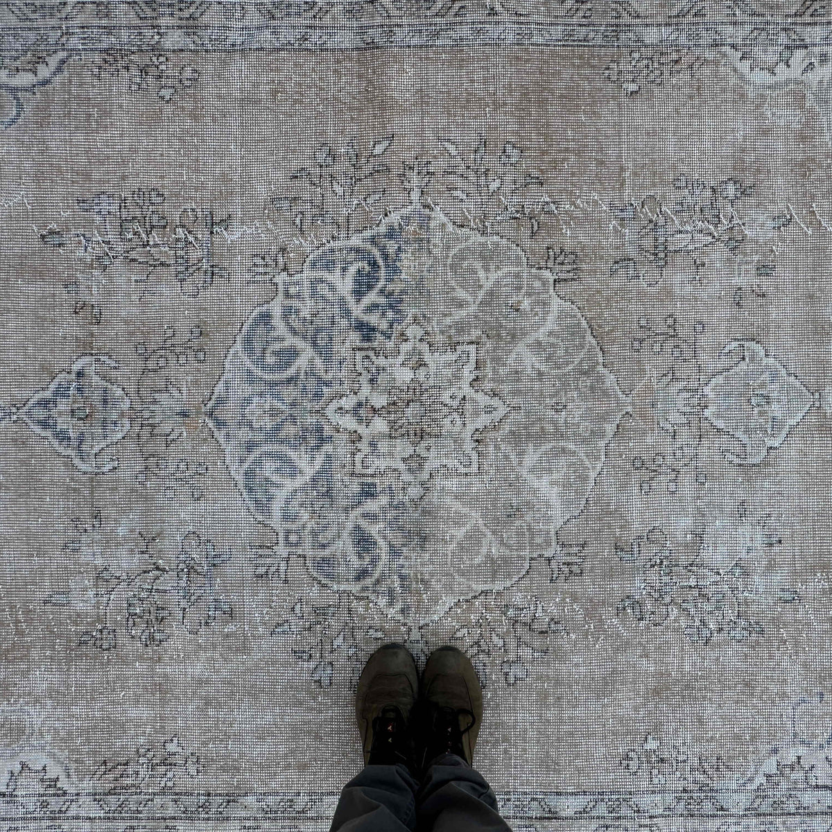 1970s blue vintage turkish rug with medallion design, hand-knotted weave and low pile.
