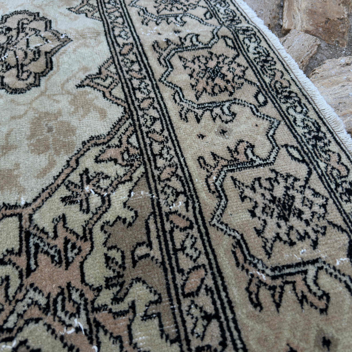 Close-up of the brown vintage turkish rug showing traditional details, hand-knotted weave, wool and cotton and low pile.