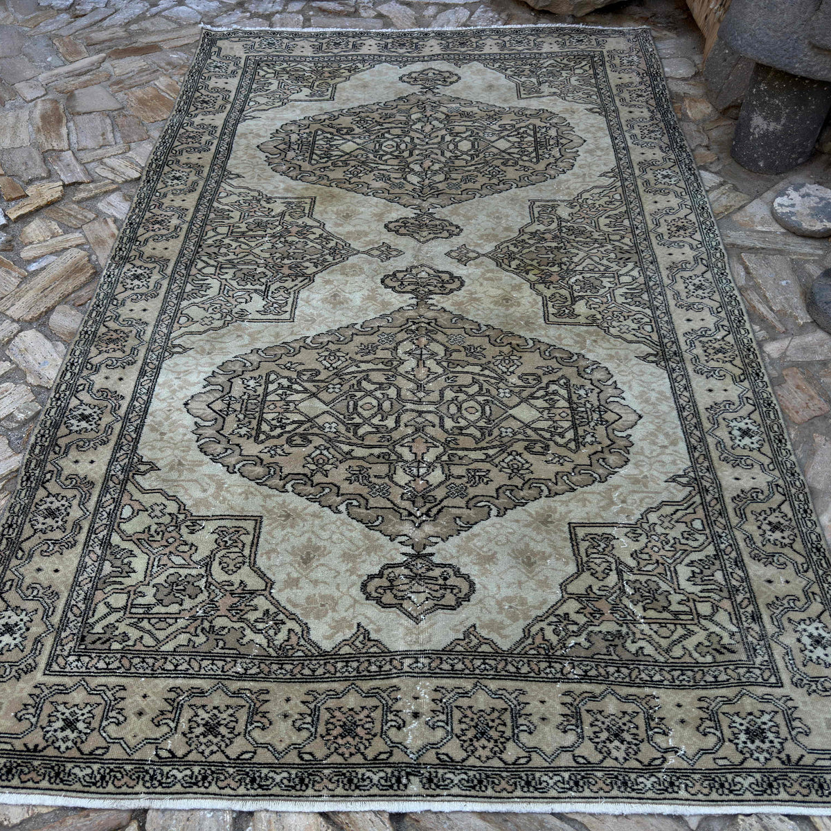 Brown 6' x 10' vintage turkish rug in wool and cotton, shown on the floor.