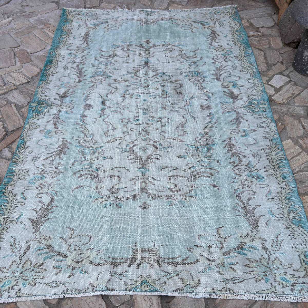Blue 6' x 8' vintage turkish rug in wool and cotton, shown on the floor.