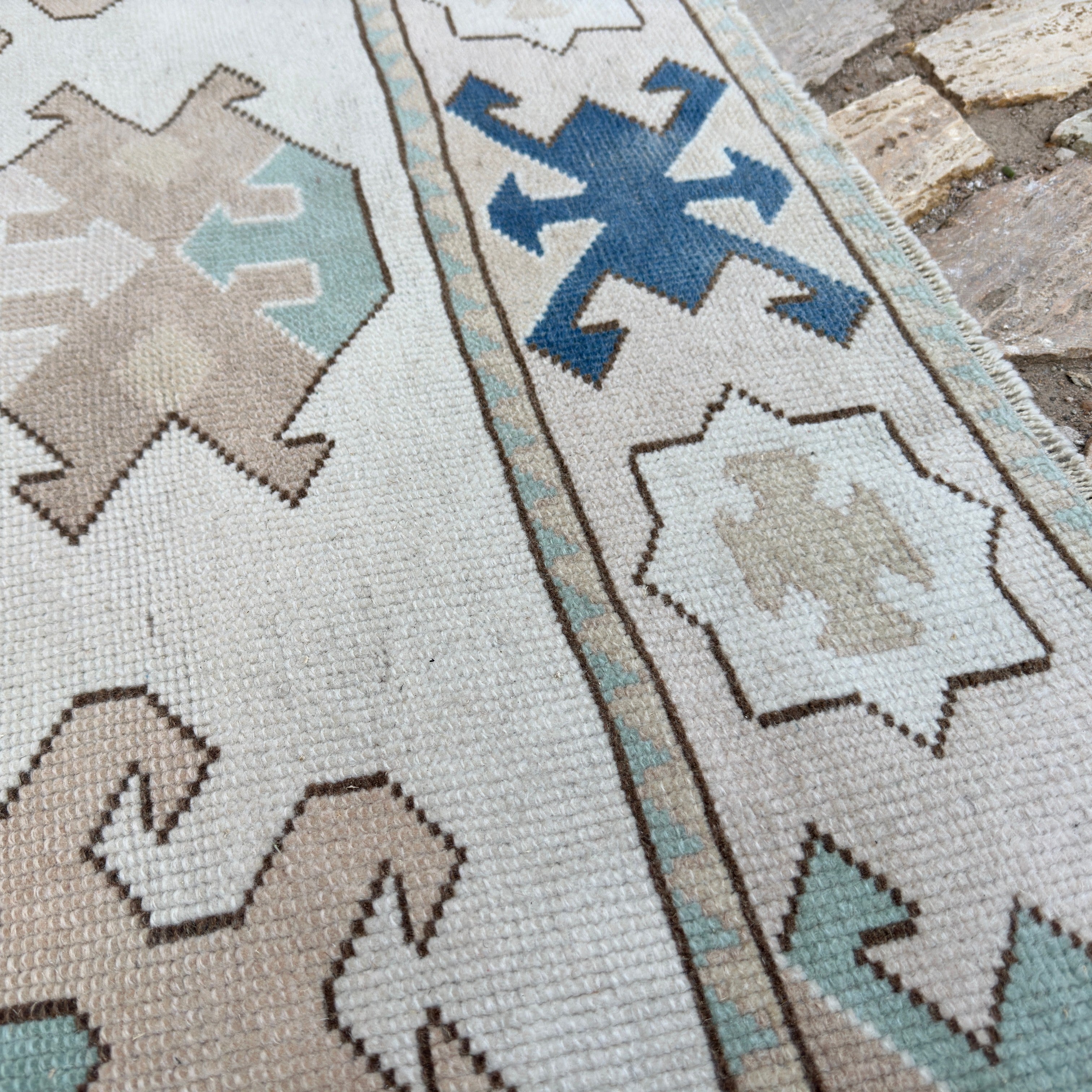 Close-up of the blue vintage turkish rug showing traditional details, hand-knotted weave, wool and cotton and low pile.