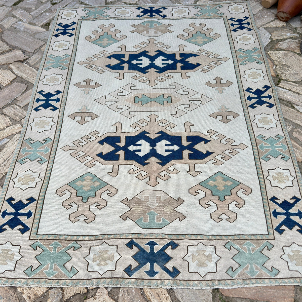 Blue 6' x 8' vintage turkish rug in wool and cotton, shown on the floor.
