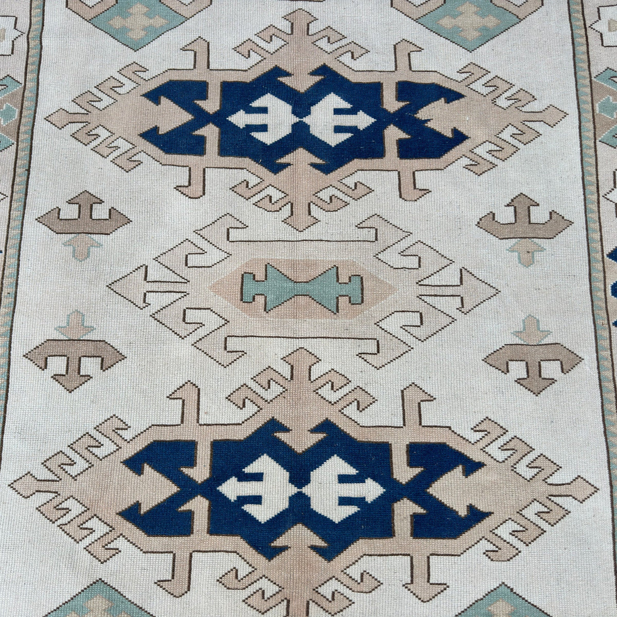 1970s blue vintage turkish rug with traditional design, hand-knotted weave and low pile.