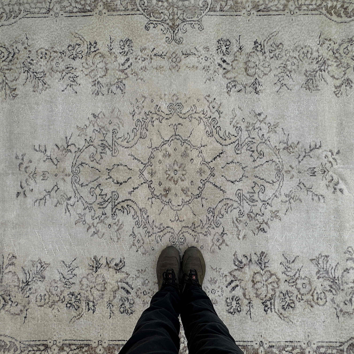 1970s beige vintage turkish rug with neutral design, hand-knotted weave and low pile.