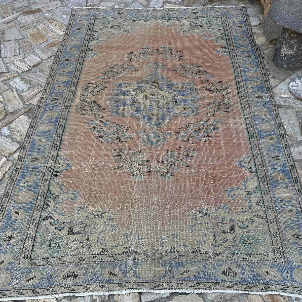 Pale Red 6' x 9' vintage turkish rug in wool and cotton, shown on the floor.