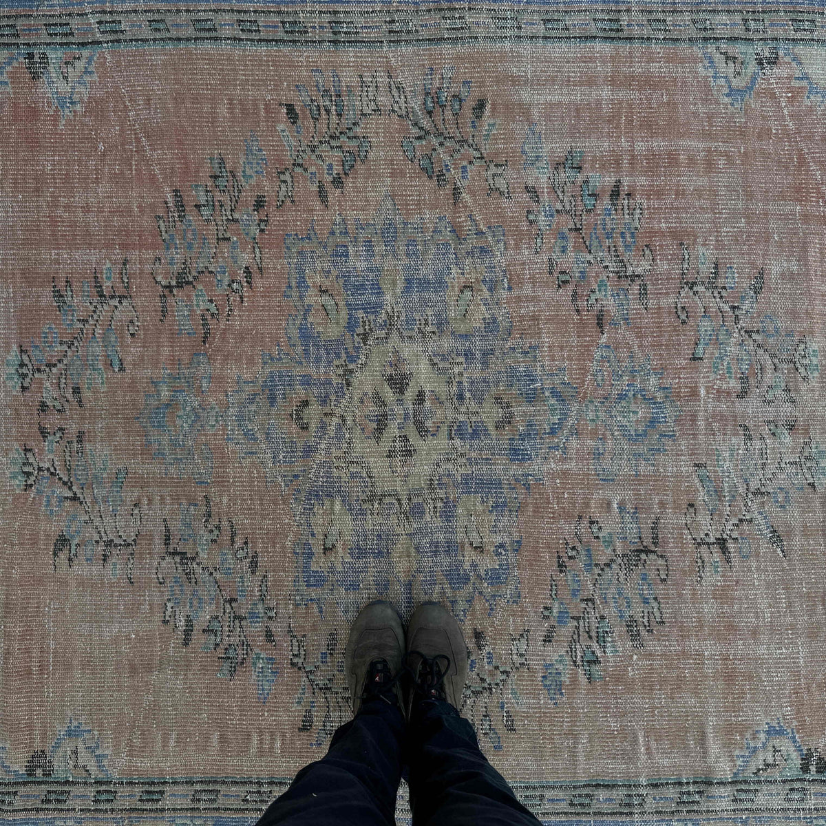 1970s pale red vintage turkish rug with medallion design, hand-knotted weave and low pile.