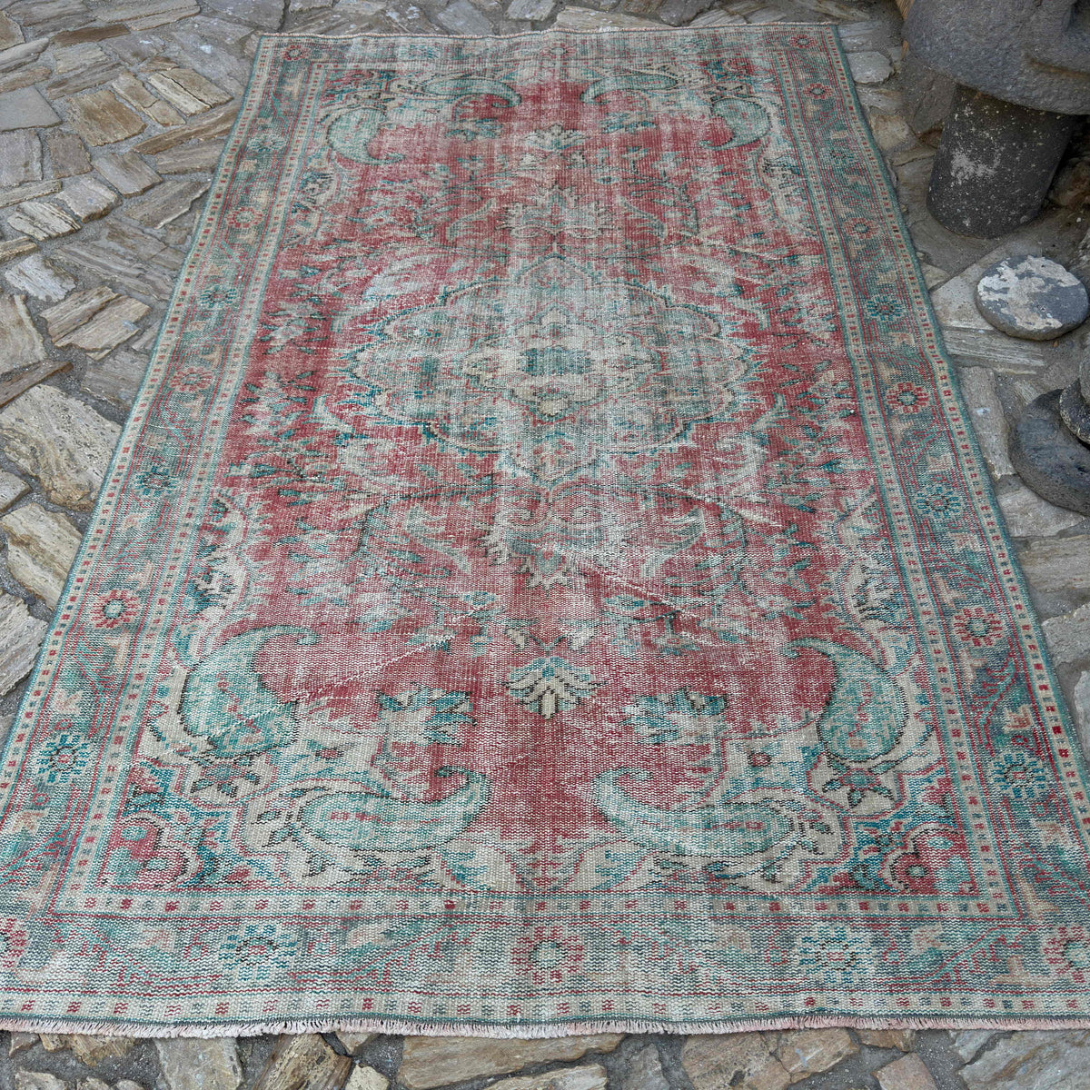 Red 6' x 9' vintage turkish rug in wool and cotton, shown on the floor.