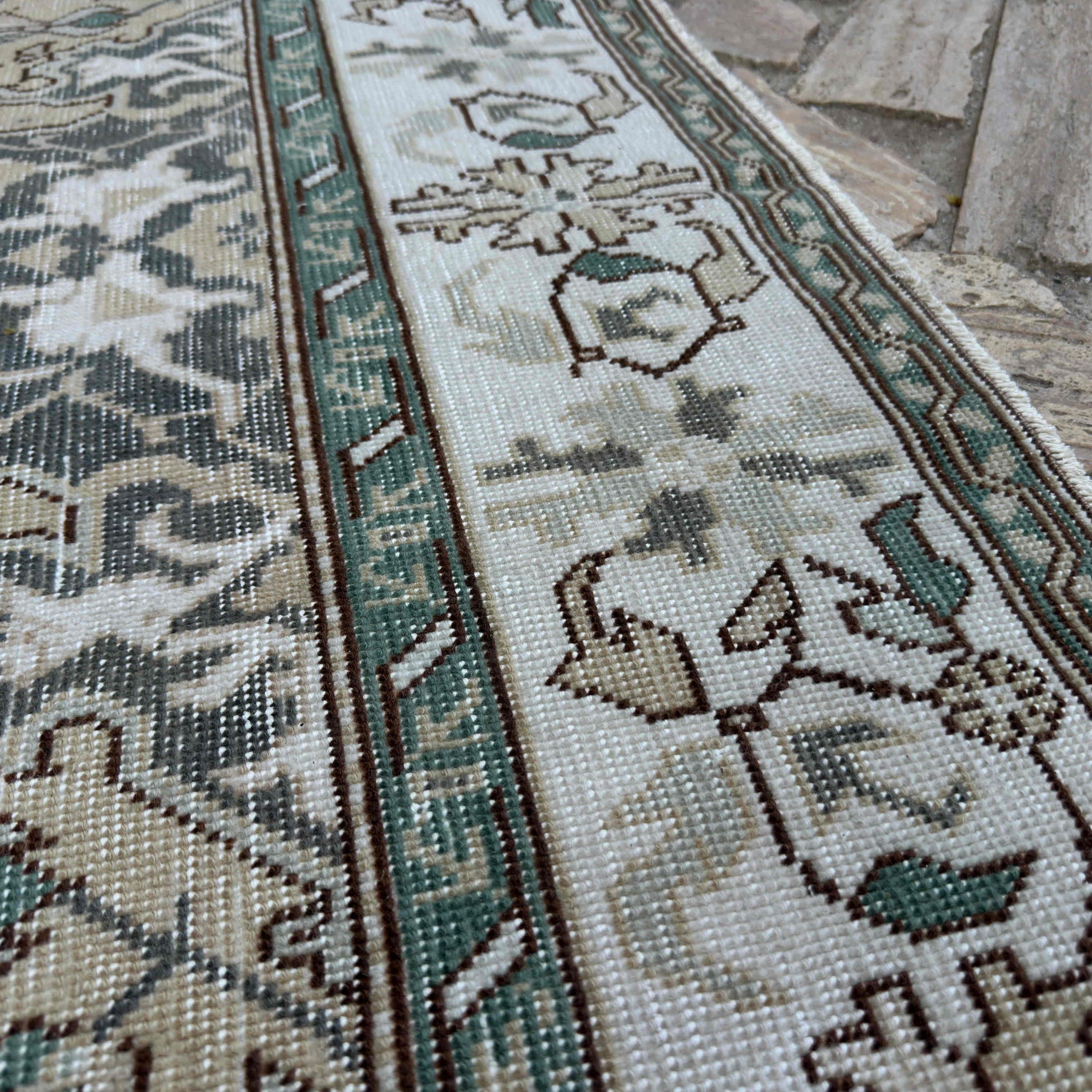 Close-up of the yellow vintage turkish rug showing traditional details, hand-knotted weave, wool and cotton and low pile.