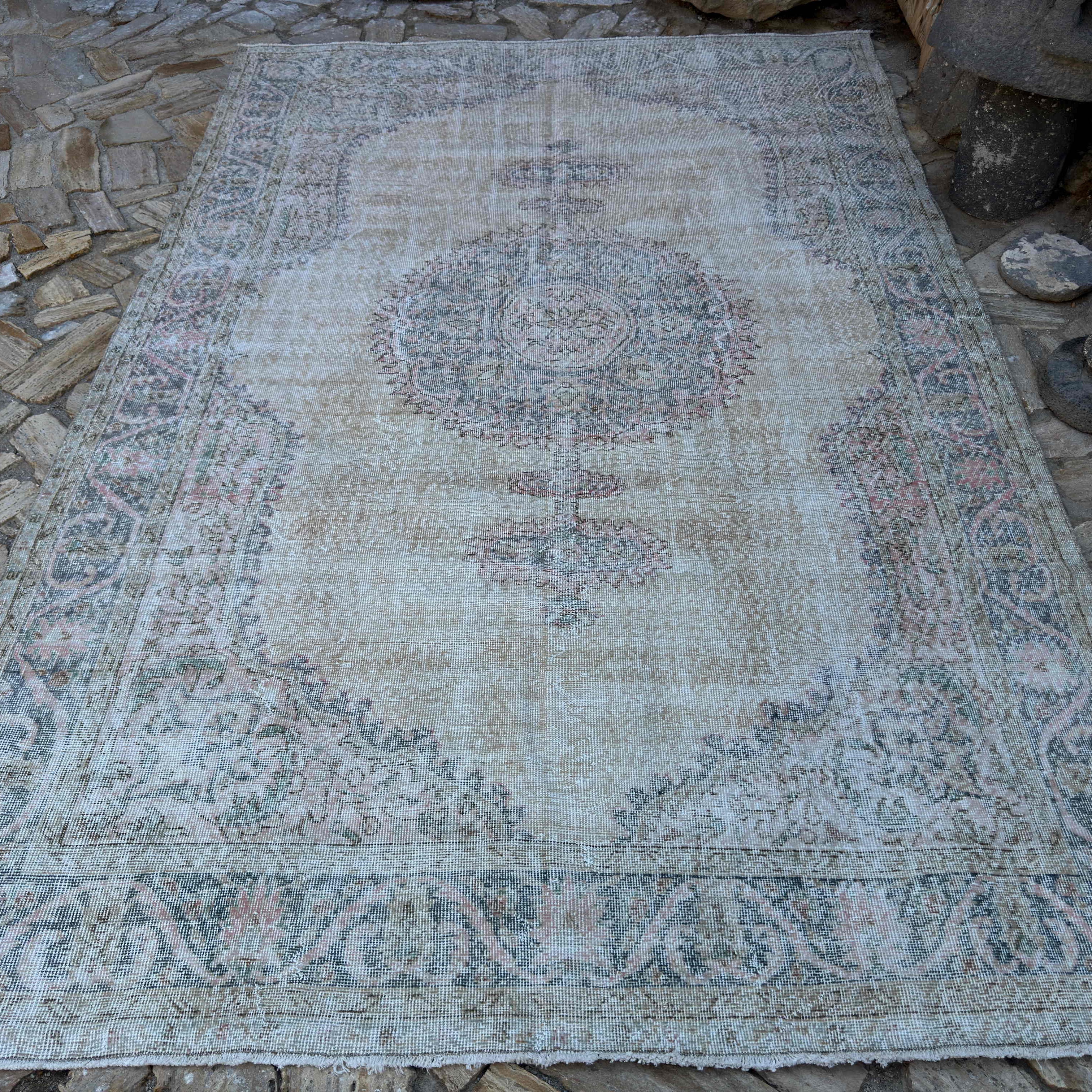 Blue 7' x 10' vintage turkish rug in wool and cotton, shown on the floor.