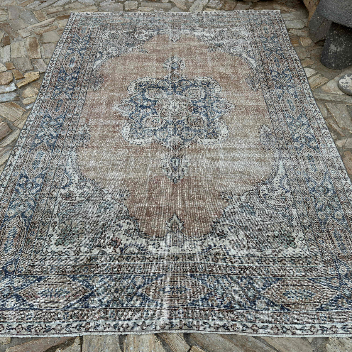 Orange 7' x 10' vintage turkish rug in wool and cotton, shown on the floor.