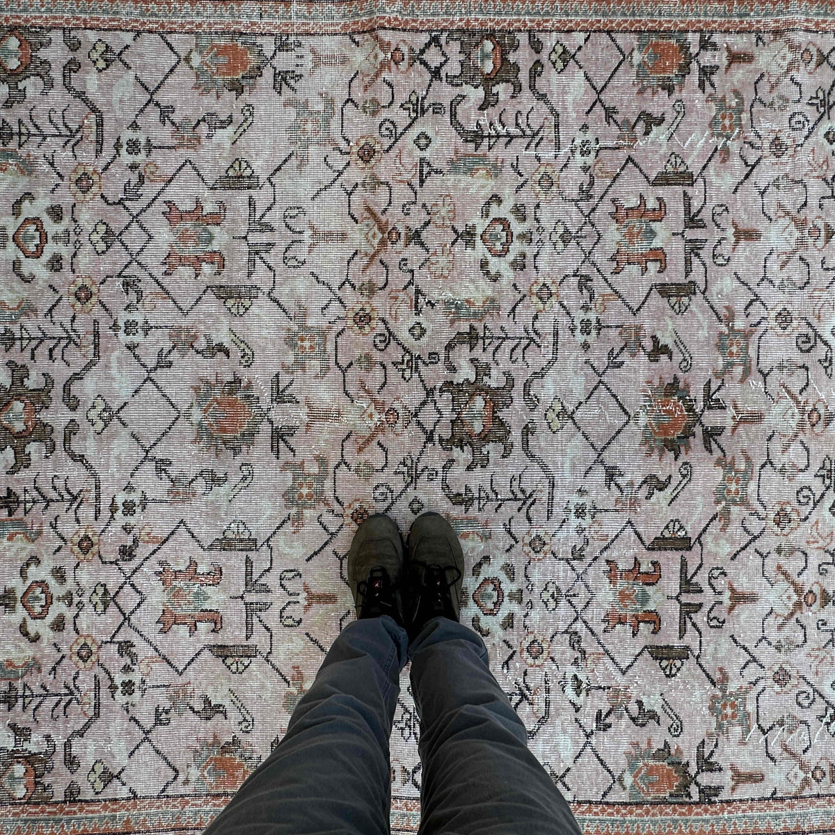 1970s pink vintage turkish rug with geometric design, hand-knotted weave and low pile.