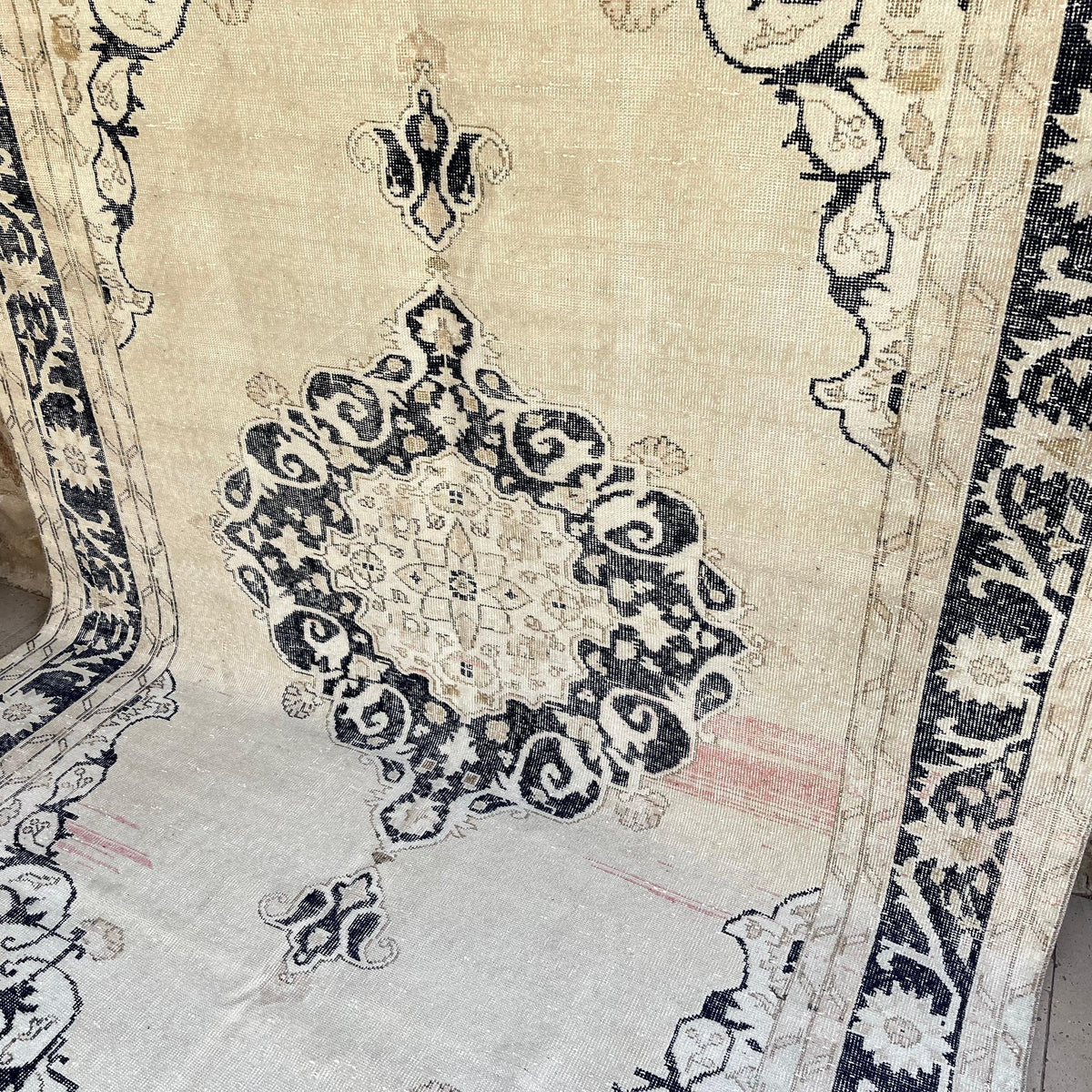 Blue 7' x 11' vintage turkish rug in wool and cotton, shown on the floor.
