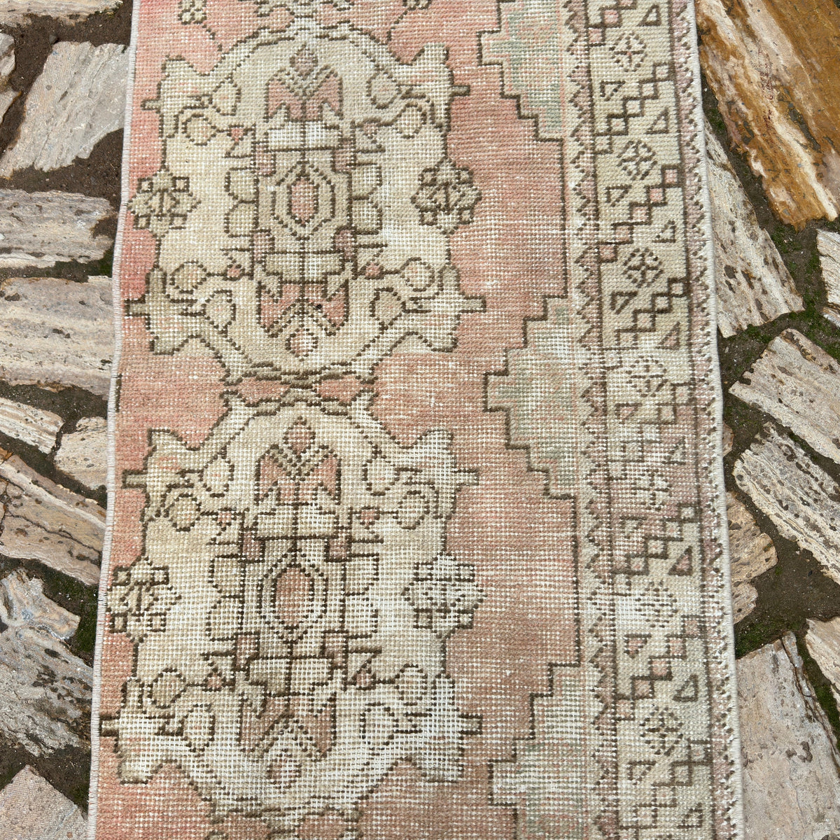 1970s pale red vintage turkish runner rug with traditional design, hand-knotted weave and low pile.