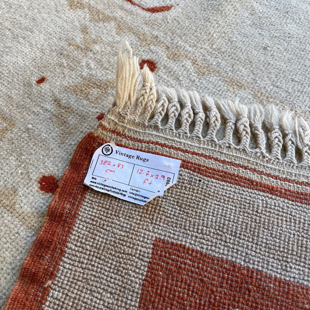 Close-up of the beige vintage turkish runner rug showing traditional details, hand-knotted weave, wool and cotton and low pile.