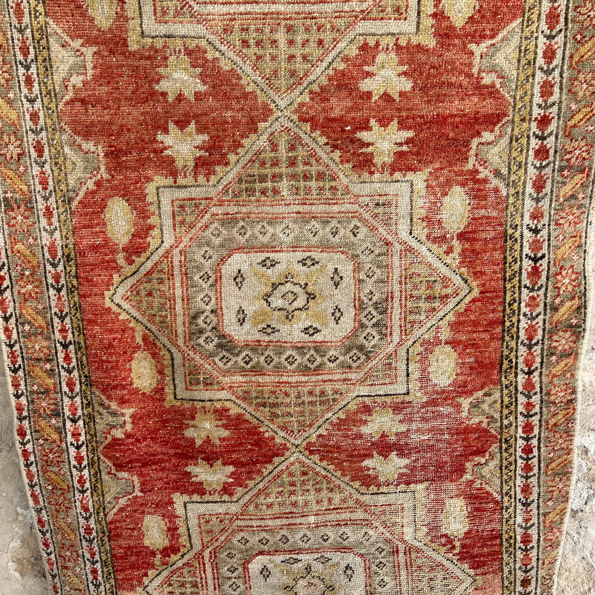 1970s red vintage turkish runner rug with traditional design, hand-knotted weave and low pile.