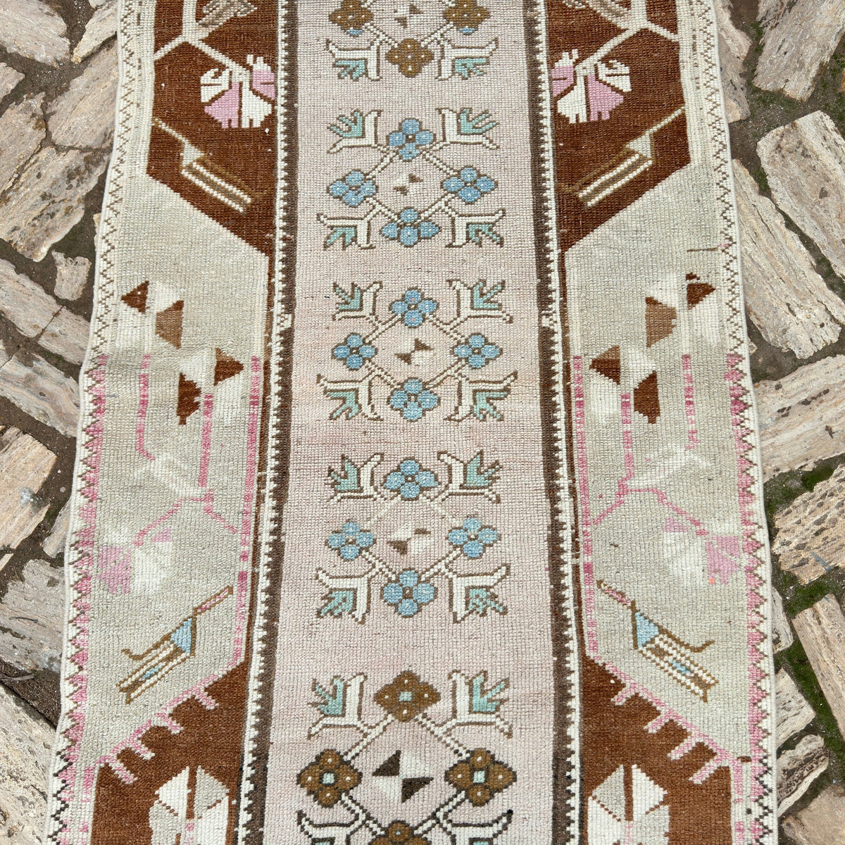 1970s pale pink vintage turkish runner rug with traditional design, hand-knotted weave and low pile.