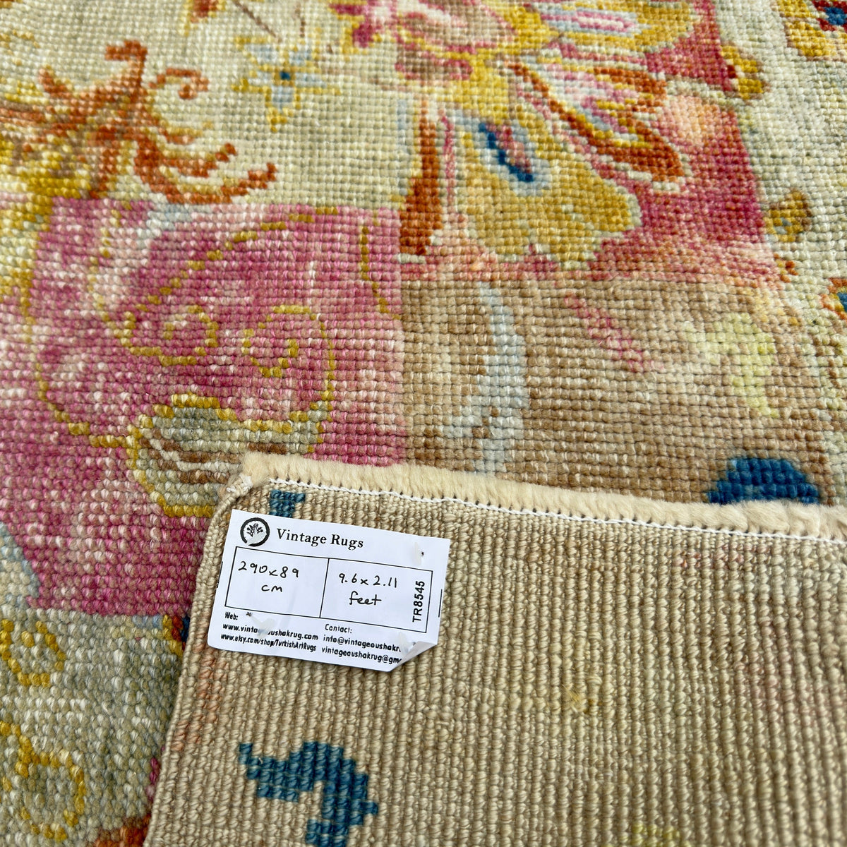 Close-up of the blue vintage turkish runner rug showing oushak details, hand-knotted weave, wool and cotton and low pile.