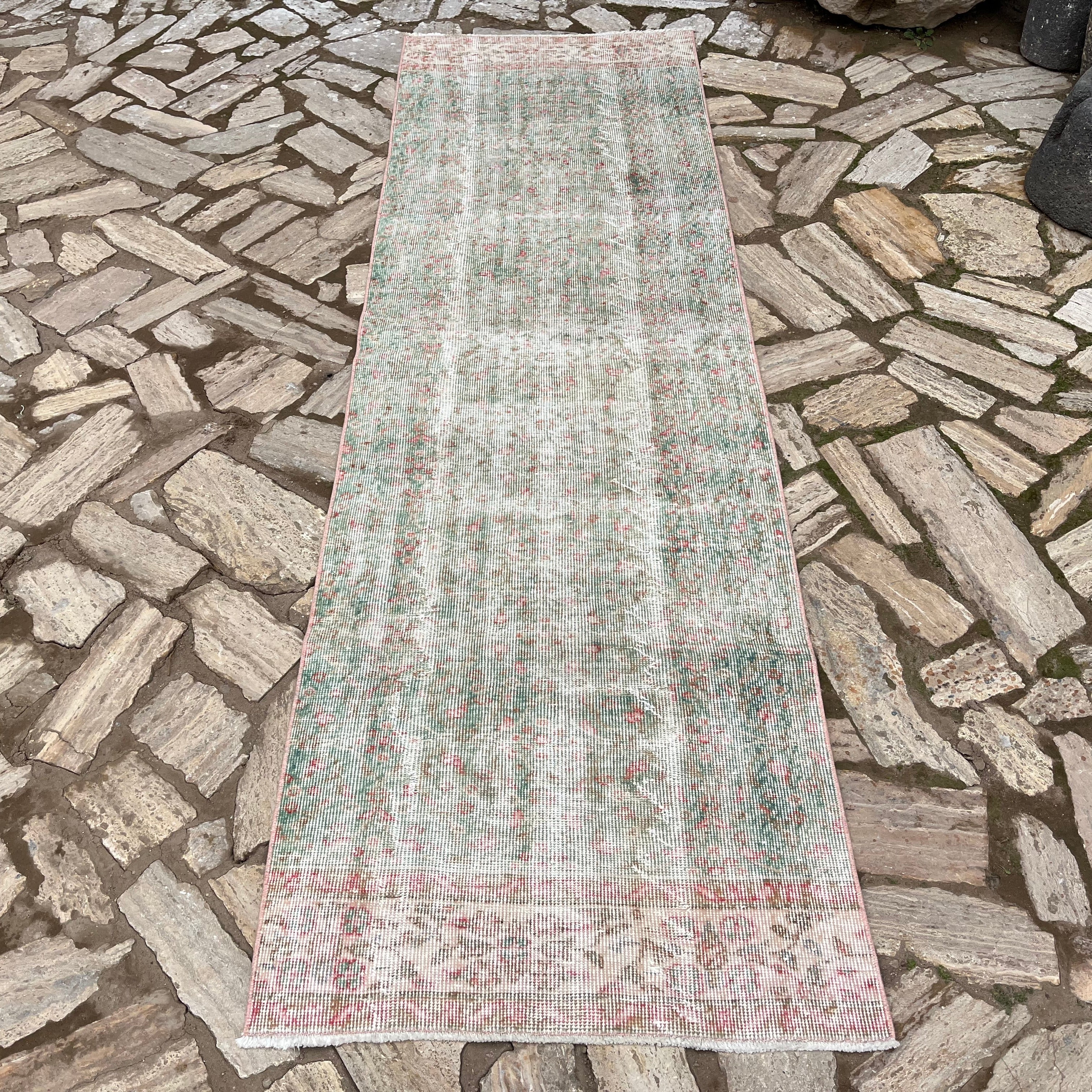 Green 3' x 9' vintage turkish runner rug in wool and cotton, shown on the floor.