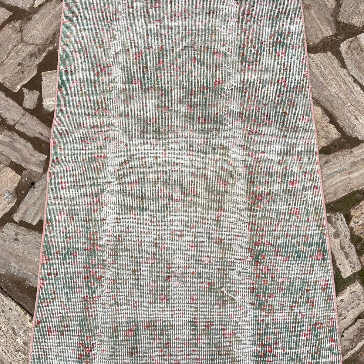 1970s green vintage turkish runner rug with floral design, hand-knotted weave and low pile.