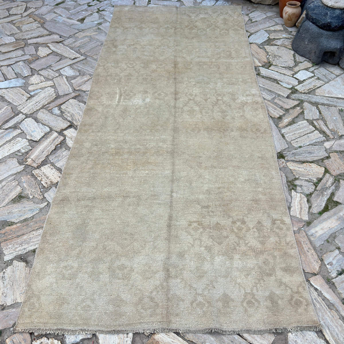 Brown 4' x 11' vintage turkish runner rug in wool and cotton, shown on the floor.