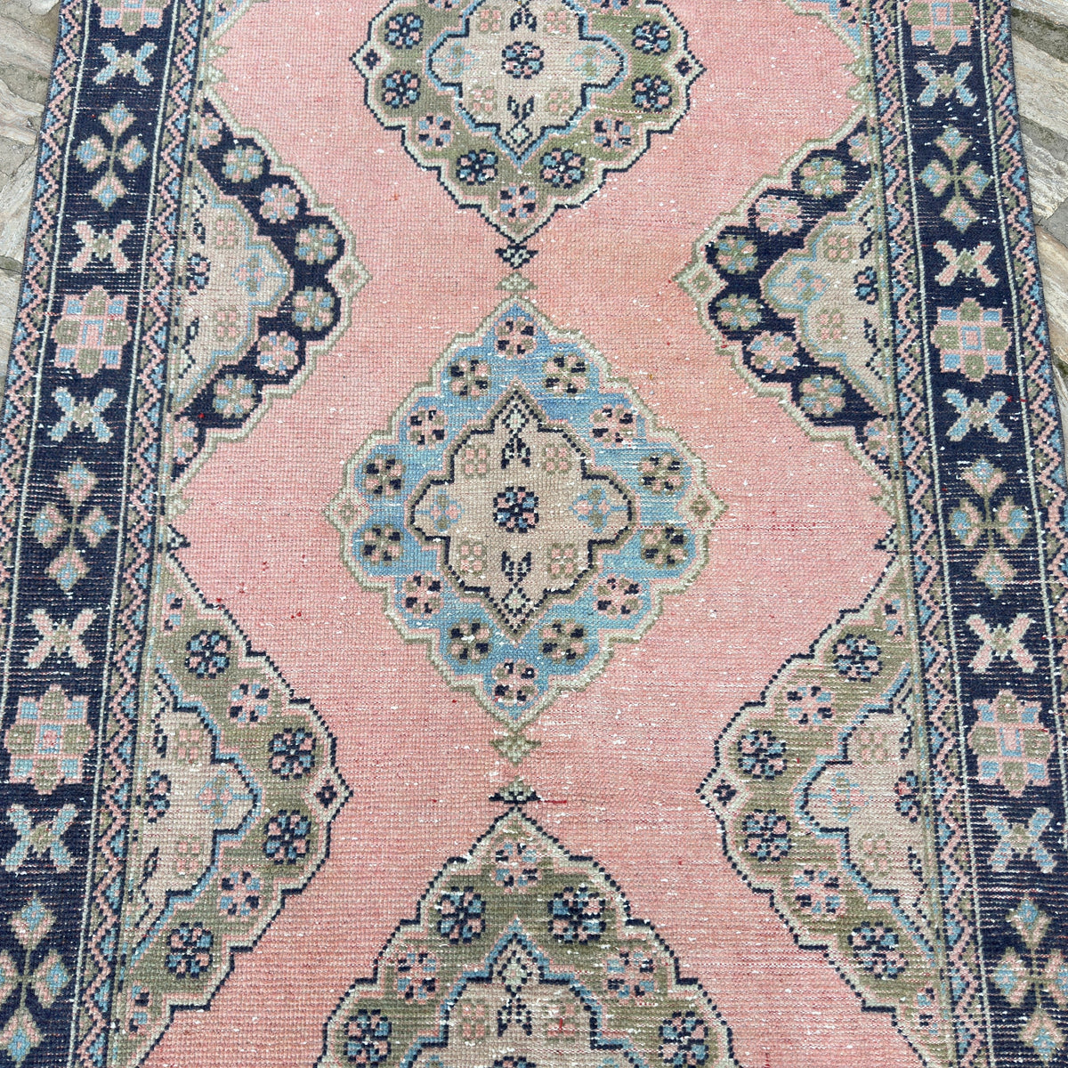 1970s pink vintage turkish runner rug with traditional design, hand-knotted weave and low pile.