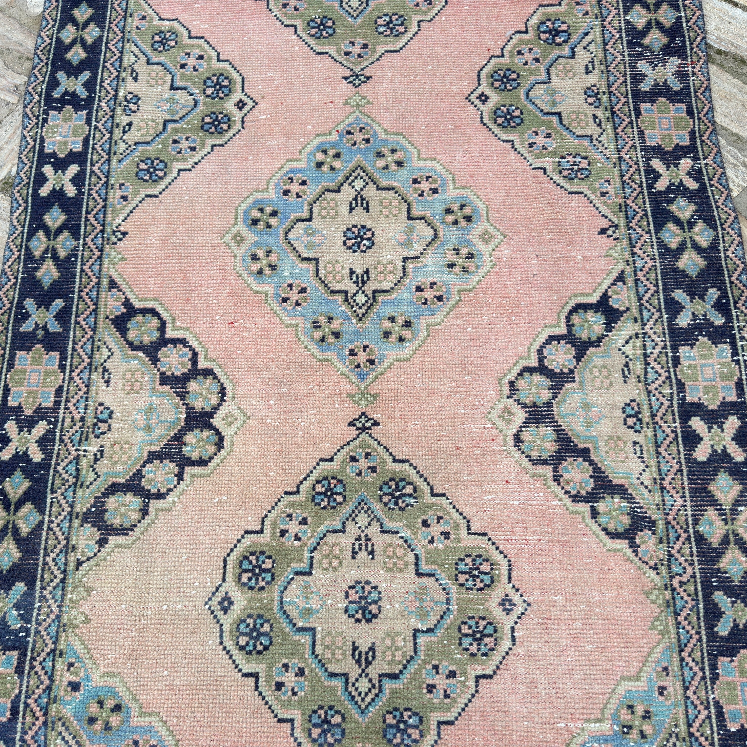 1970s pink vintage turkish runner rug with traditional design, hand-knotted weave and low pile.