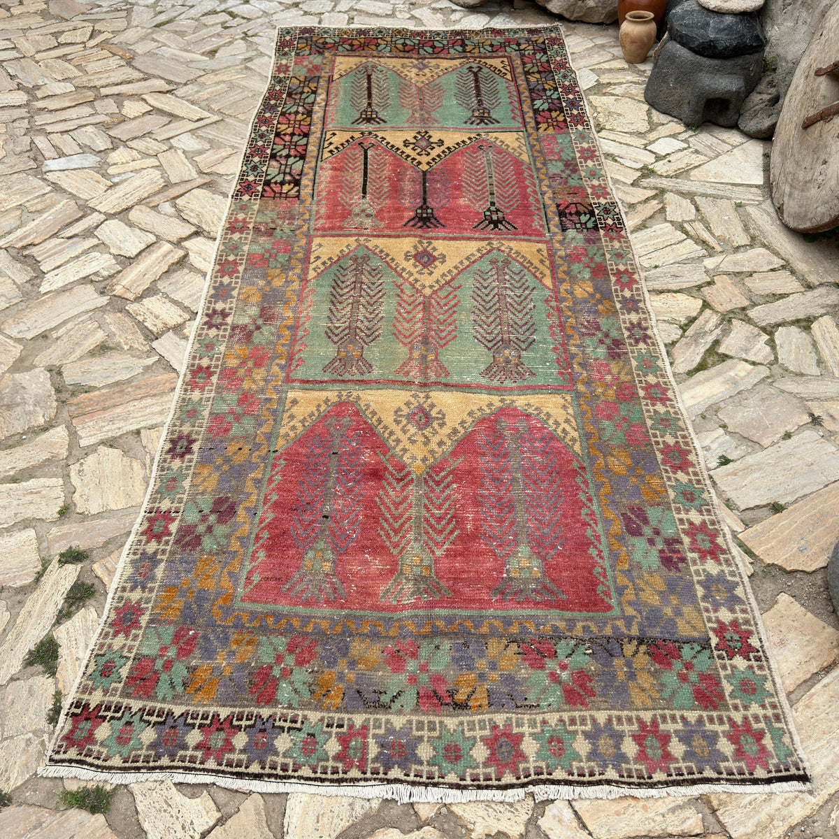 Green 5' x 12' vintage turkish runner rug in wool and cotton, shown on the floor.