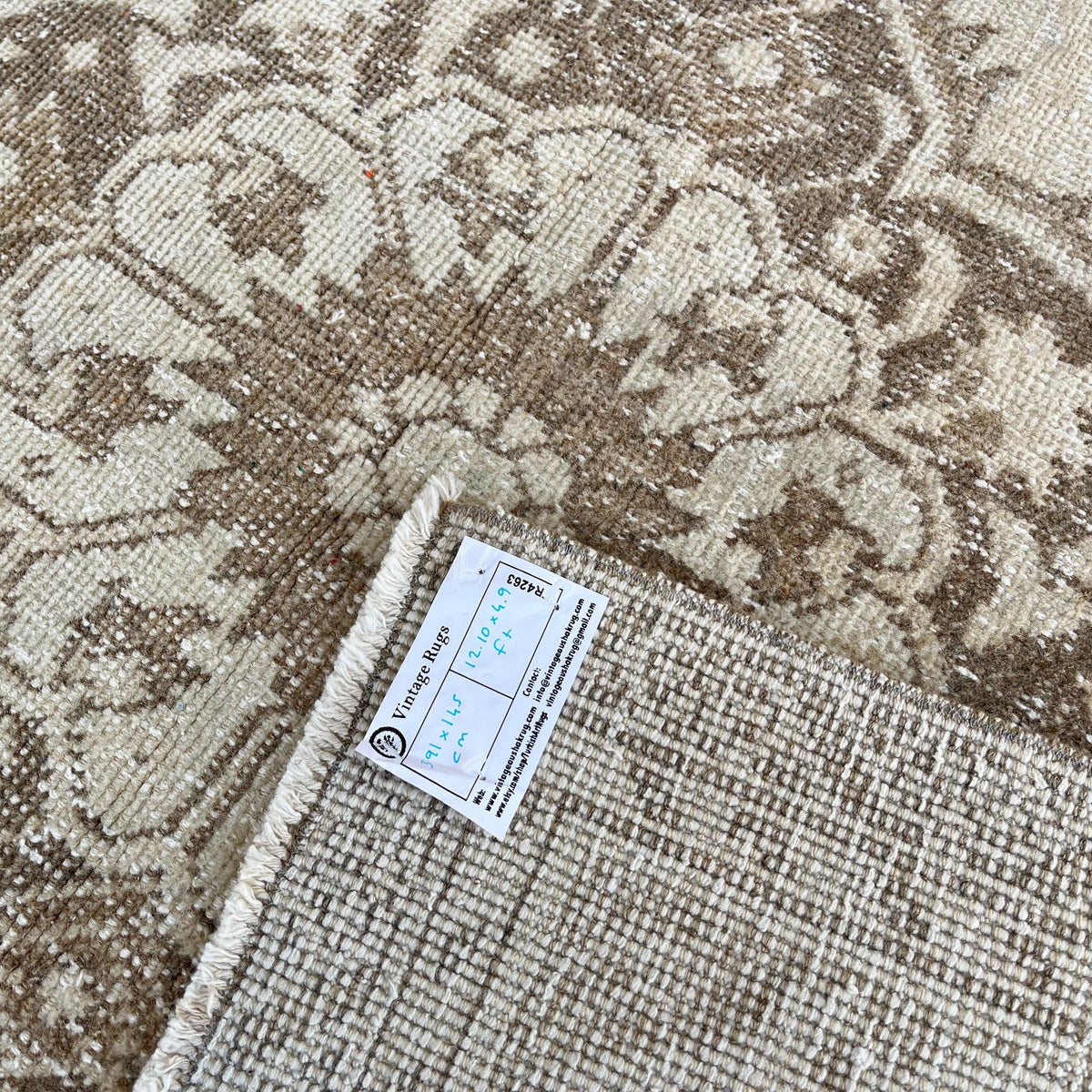 Close-up of the brown vintage turkish runner rug showing neutral details, hand-knotted weave, wool and cotton and low pile.