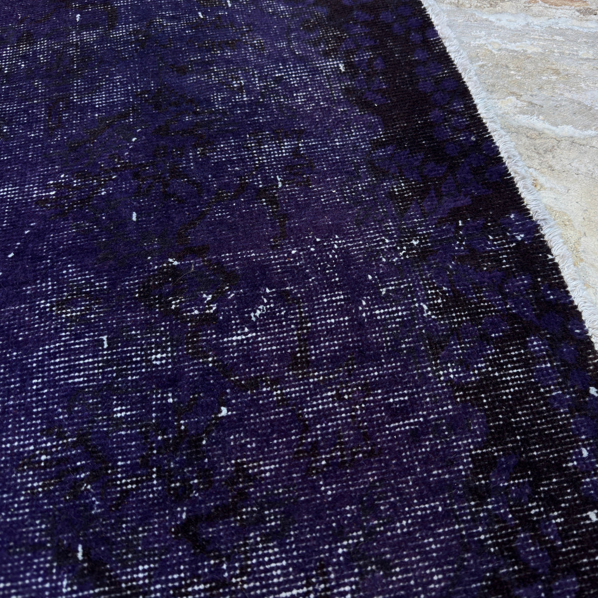 1970s purple vintage Turkish wool overdyed rug with overdyed design, hand-knotted weave and low pile.