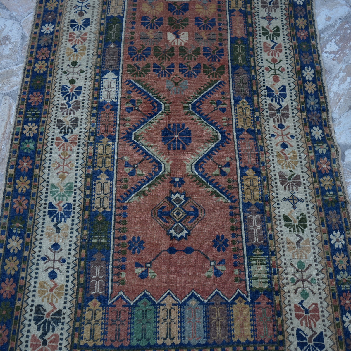 Close-up of the blue vintage Turkish wool rug showing traditional details, hand-knotted weave, wool and low pile.